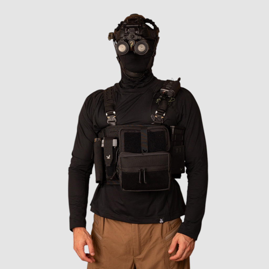 Night Heron Israel Alpha Chest Rig tactical vest with MOLLE panels and pouches, black Cordura, worn by a model.