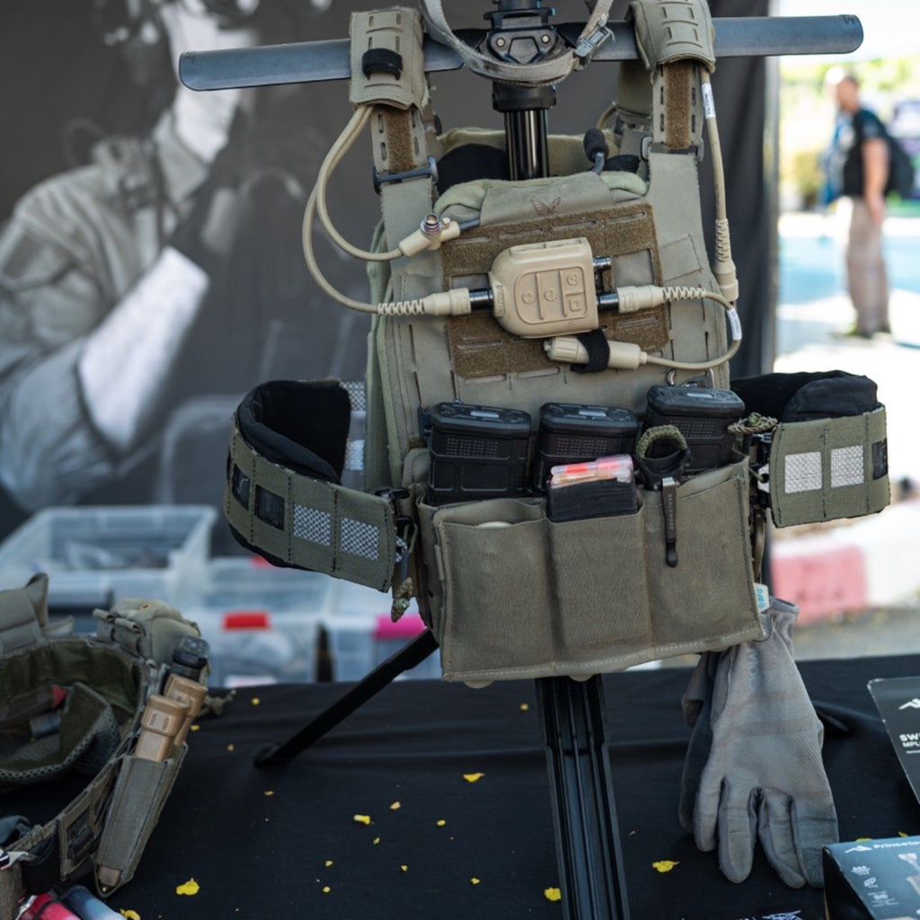 Night Heron Israel SWIFT portable tactical gear stand holding a plate carrier vest and helmet with night vision.