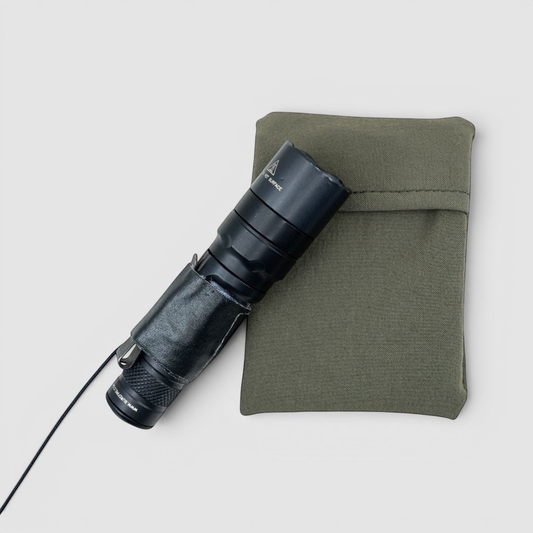 Night Heron Israel olive green nylon tactical pouch with black flashlight attached via MOLLE system